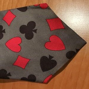 Grey, black and red novelty tie with suits from cards. Unnoticeable stain. Cute